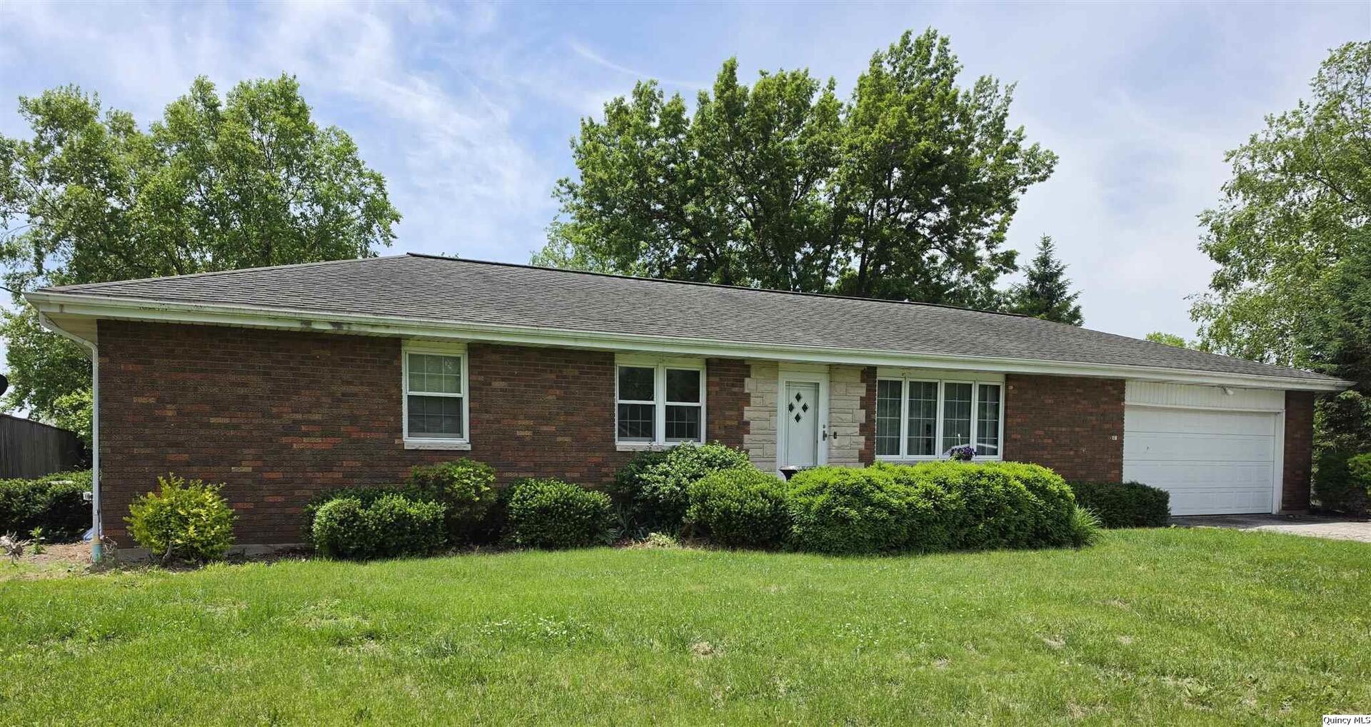 103 East Spring Street Camp Point, IL 62320 - Photo 1 of 8 front view of a house with a yard