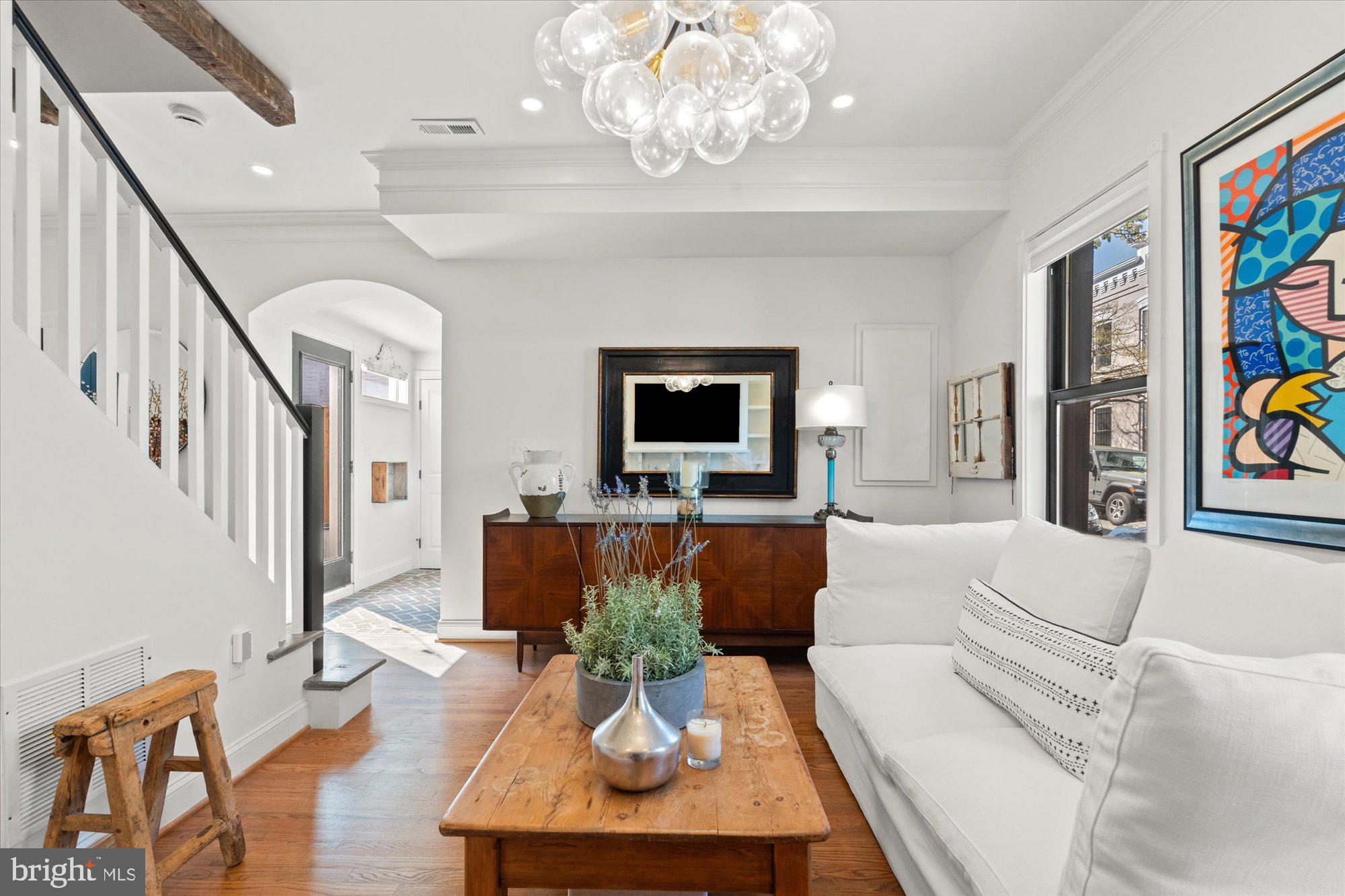 629 Pickford Place Northeast Washington, DC 20002 - Photo 11 of 41 a living room with furniture a chandelier and a flat screen tv