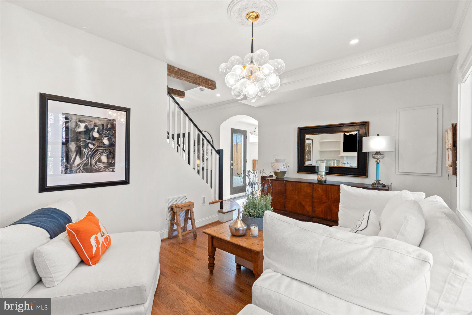 629 Pickford Place Northeast Washington, DC 20002 - Photo 12 of 41 a living room with furniture a chandelier and a flat screen tv