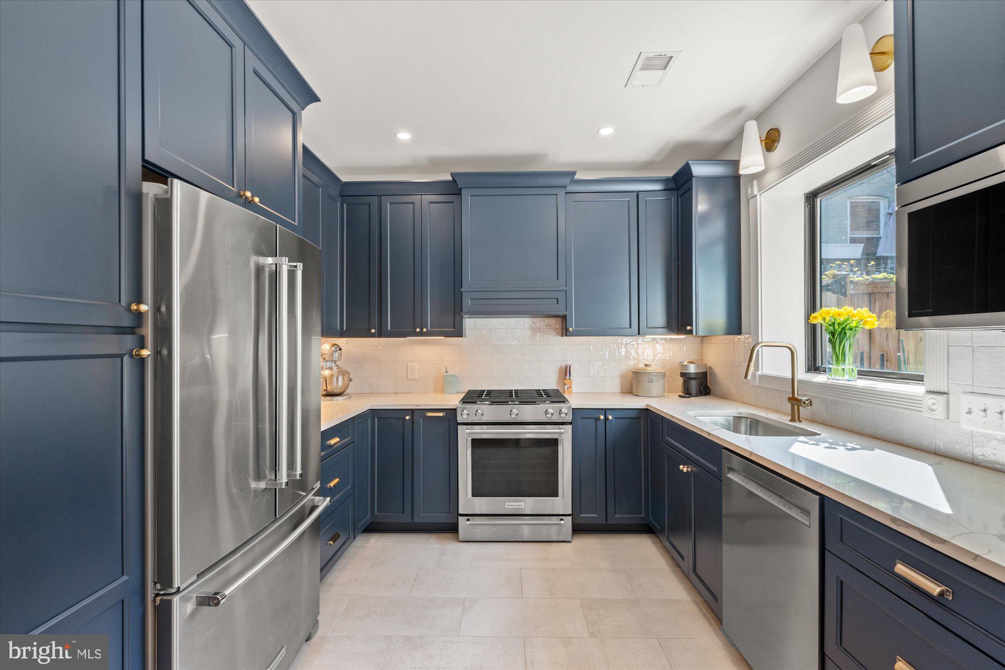 629 Pickford Place Northeast Washington, DC 20002 - Photo 19 of 41 a kitchen with kitchen island stainless steel appliances a sink stove and refrigerator