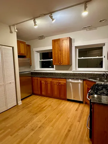 a kitchen with stainless steel appliances granite countertop a sink and a stove top oven
