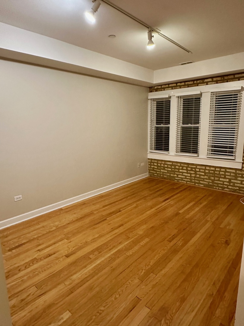 2537.5 Prairie Avenue, Unit 3S Evanston, IL 60201 - Photo 4 of 8 a view of an empty room with wooden floor and a window