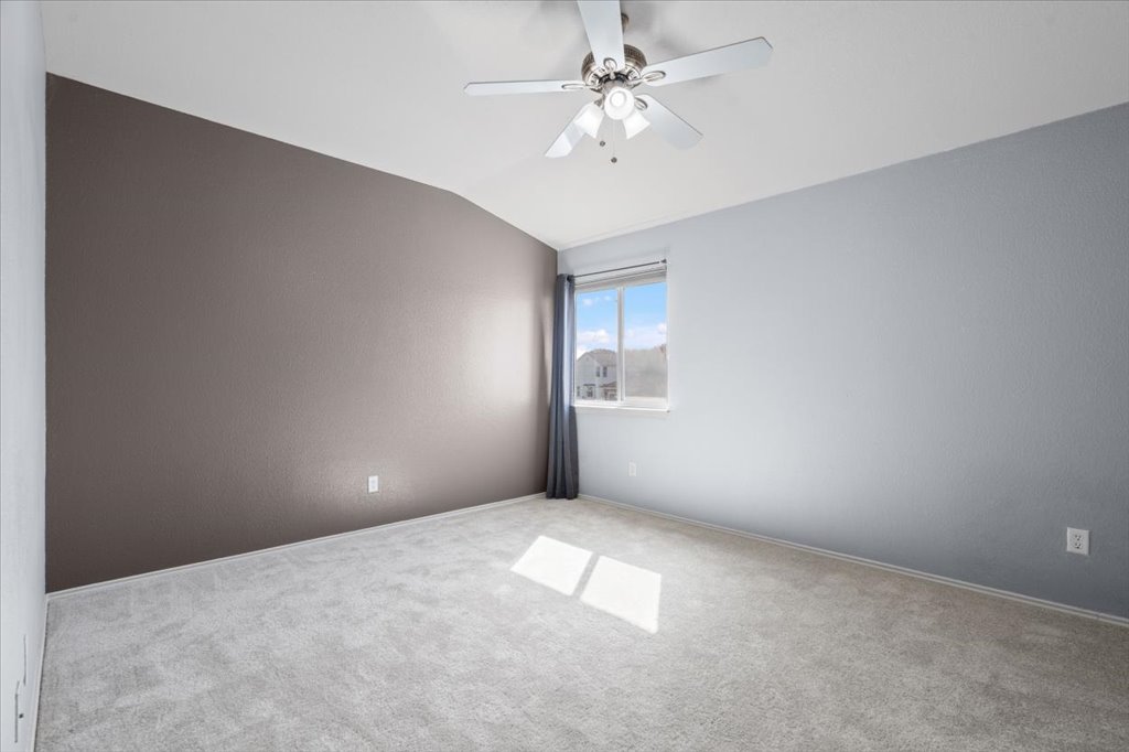 633 Fairway Kyle, TX 78640 - Photo 14 of 22 an empty room with windows and fan