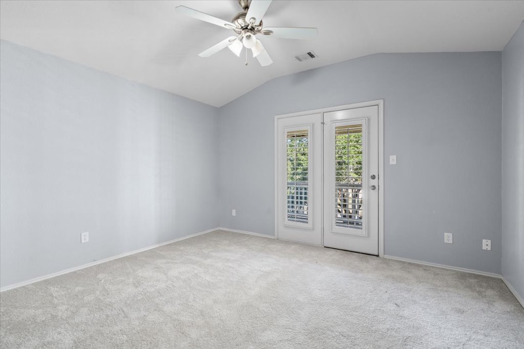 633 Fairway Kyle, TX 78640 - Photo 15 of 22 an empty room with windows and chandelier fan