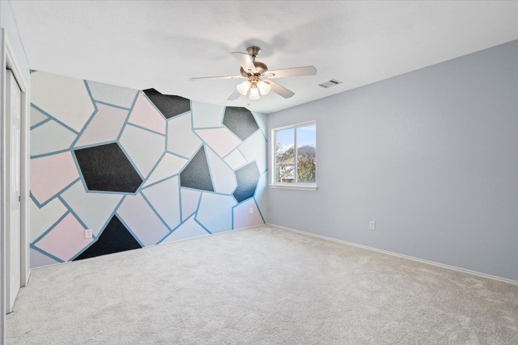 633 Fairway Kyle, TX 78640 - Photo 17 of 22 a view of a livingroom with a chandelier fan and wooden floor