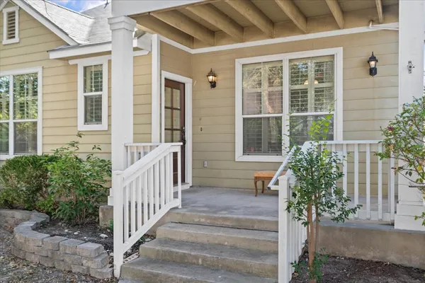 a view of a house with a window and wooden fence