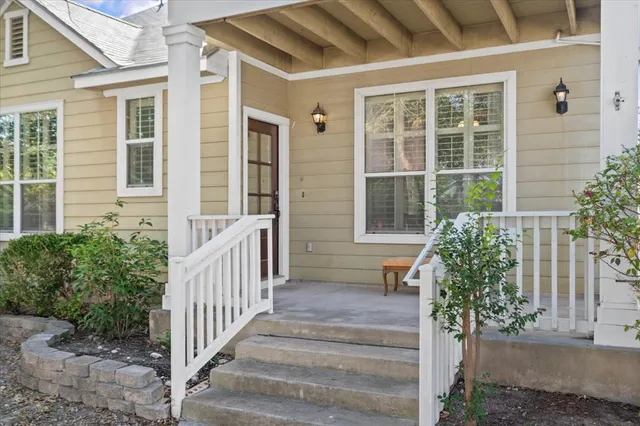 a view of a house with a window and wooden fence