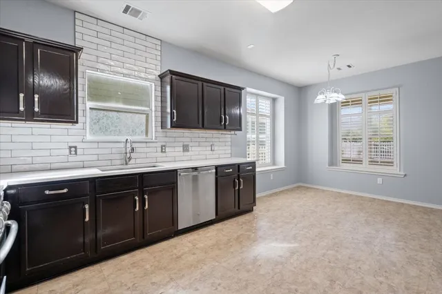 a spacious bathroom with a granite countertop double vanity sink and mirror