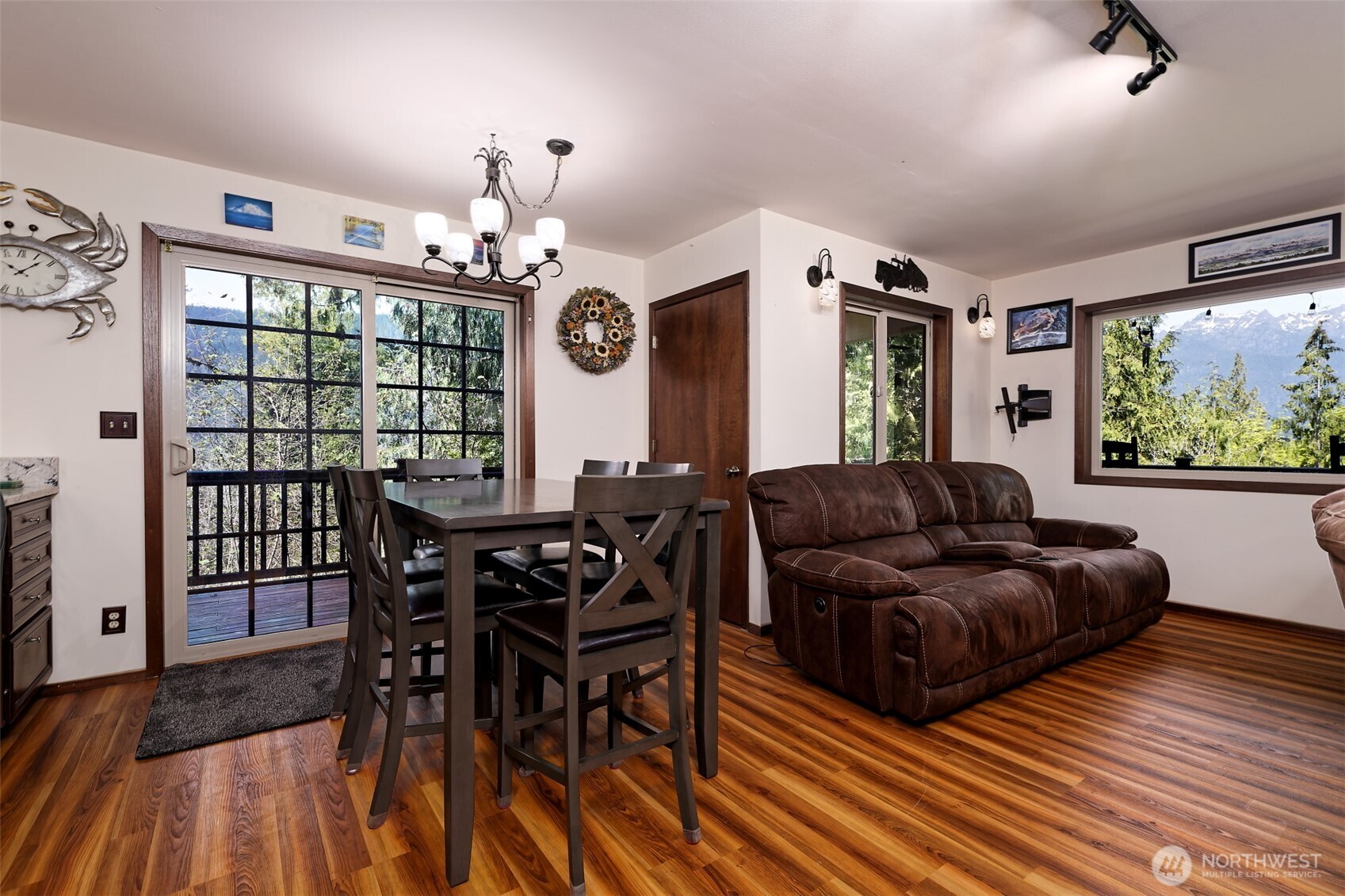 5791 North Lake Cushman Road Hoodsport, WA 98548 - Photo 11 of 39 a living room with furniture a large window and wooden floor