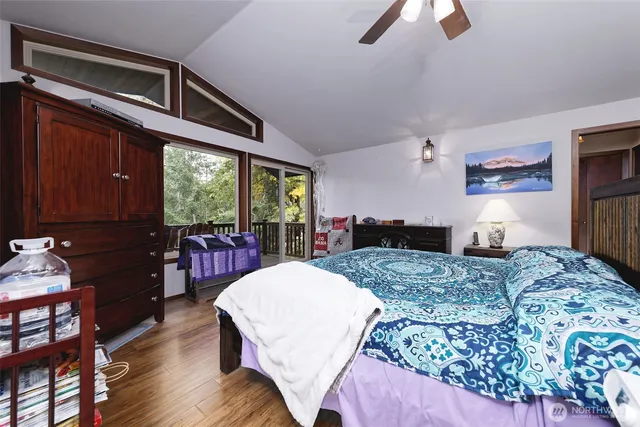 a bed sitting in a spacious bedroom next to a window