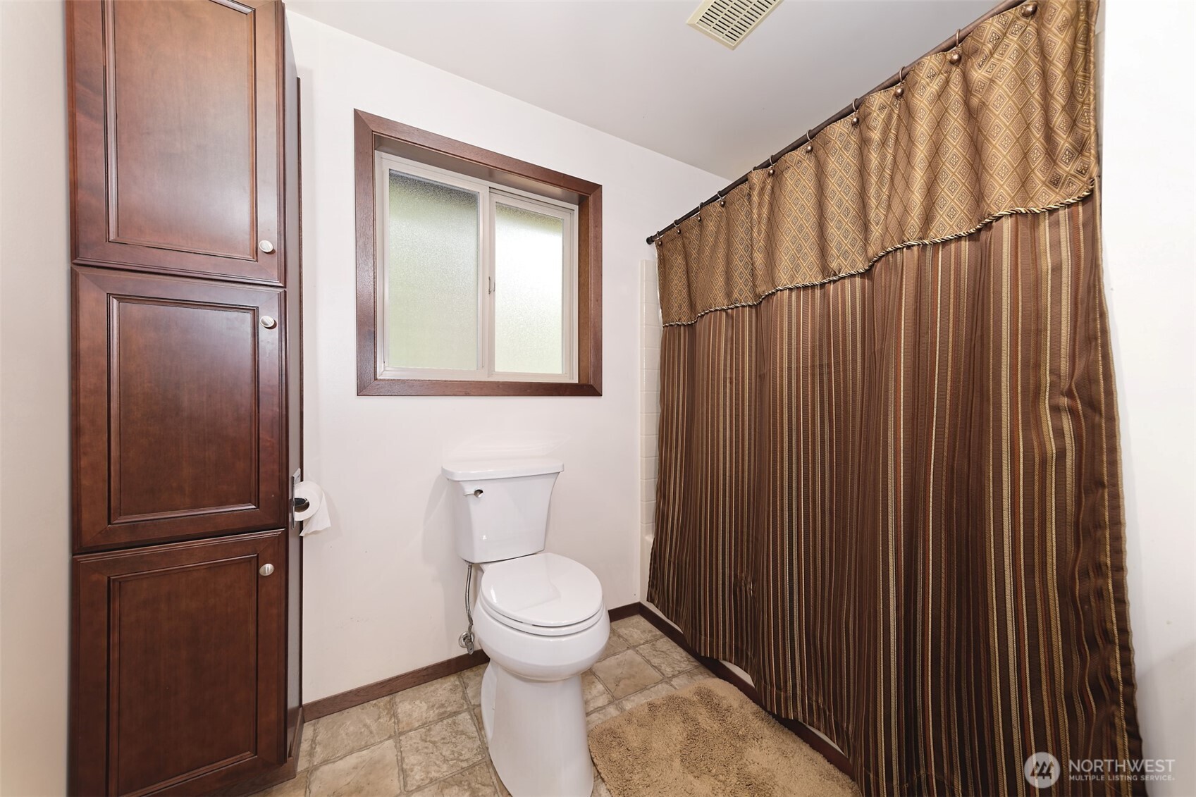 5791 North Lake Cushman Road Hoodsport, WA 98548 - Photo 19 of 39 a bathroom with a toilet a sink and mirror