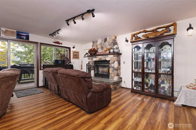 a kitchen with stainless steel appliances granite countertop a refrigerator a sink dishwasher a stove and a refrigerator with wooden floor