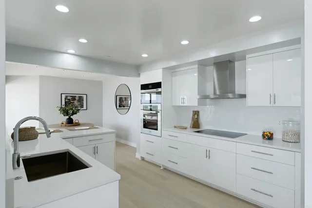 a kitchen with a sink stove and cabinets