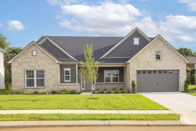 a view of a brick house with a yard