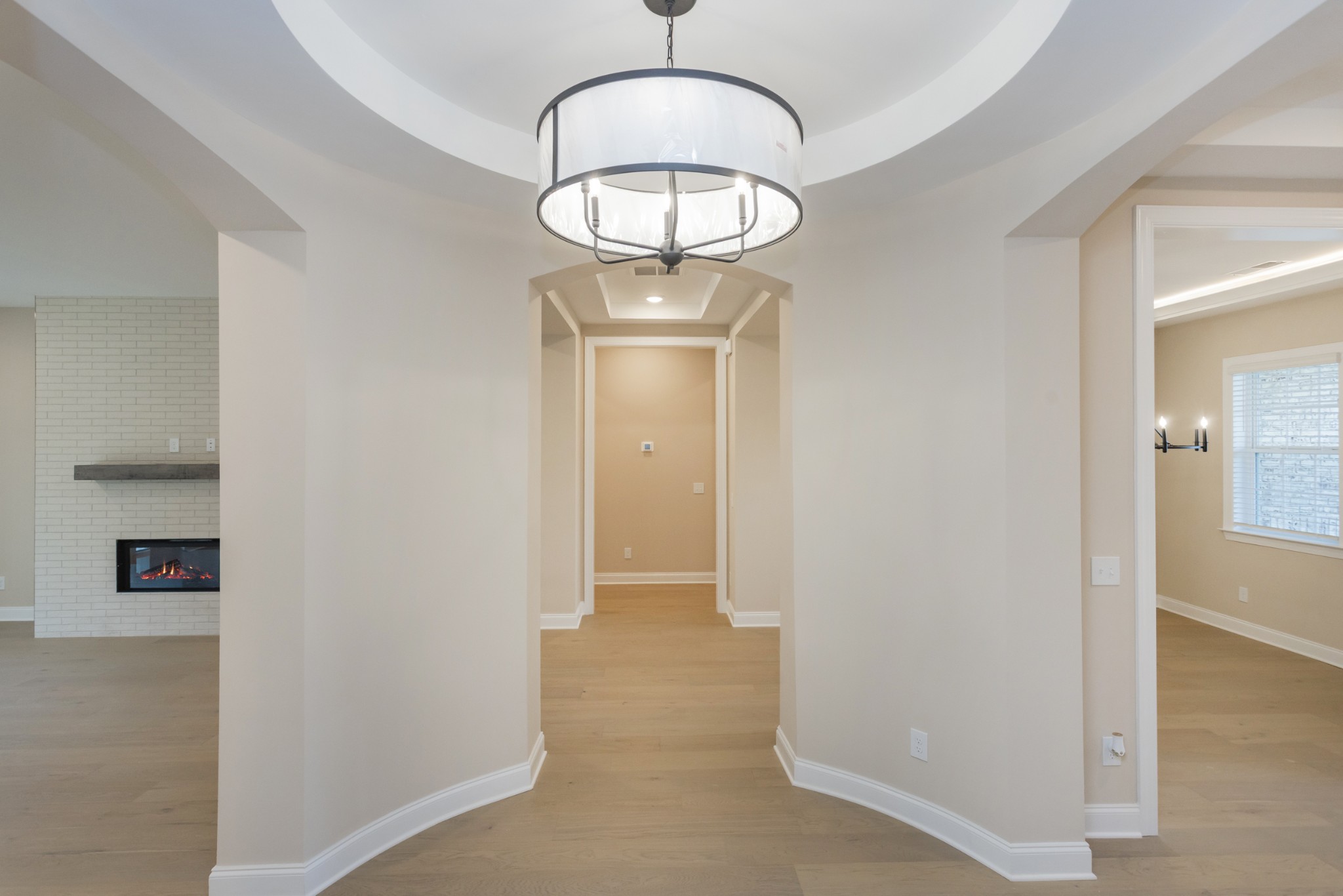 7006 Thunderhead Way Spring Hill, TN 37174 - Photo 12 of 58 a view of a hallway with wooden floor and a chandelier