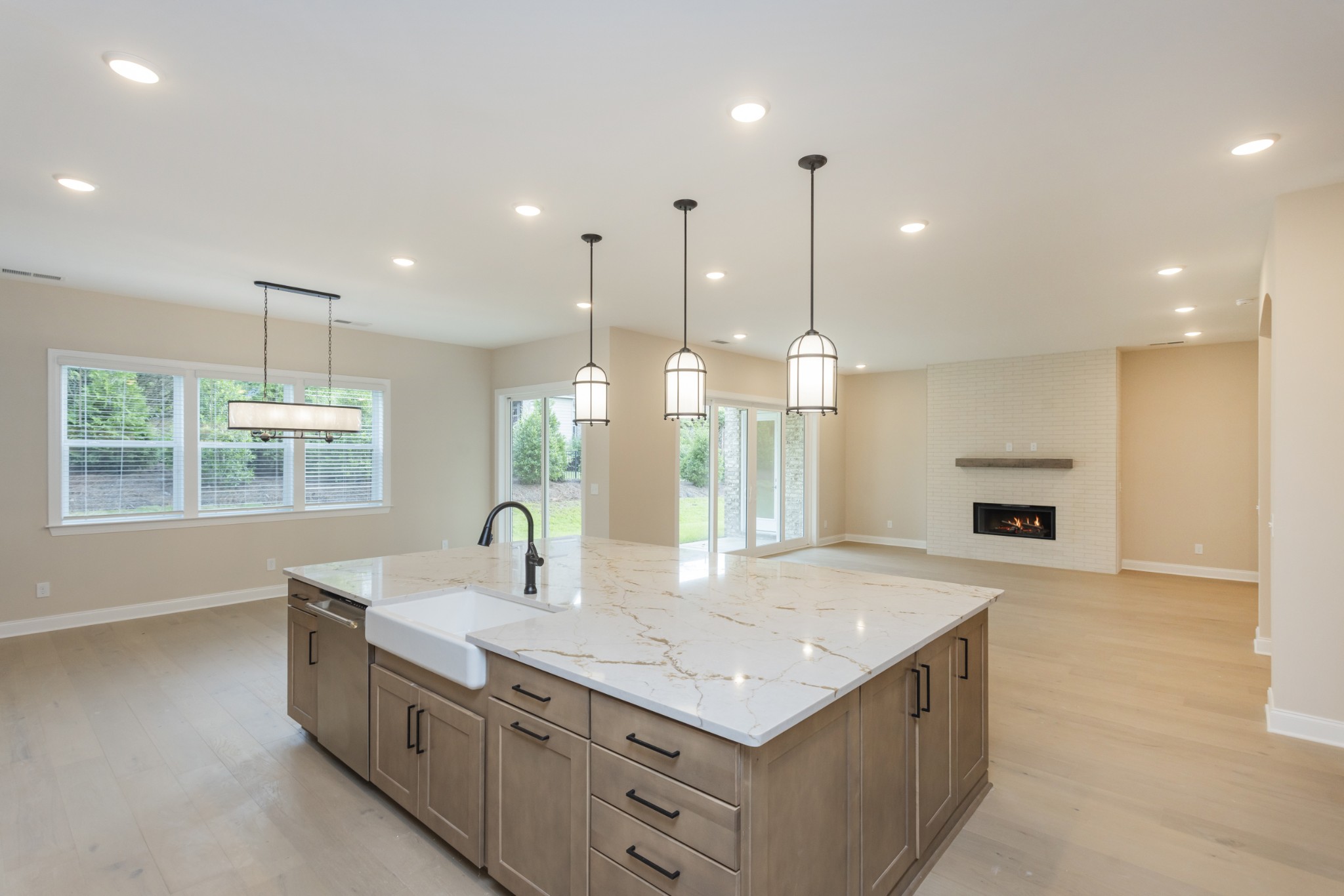 7006 Thunderhead Way Spring Hill, TN 37174 - Photo 13 of 58 a kitchen with kitchen island a sink stainless steel appliances and a counter top
