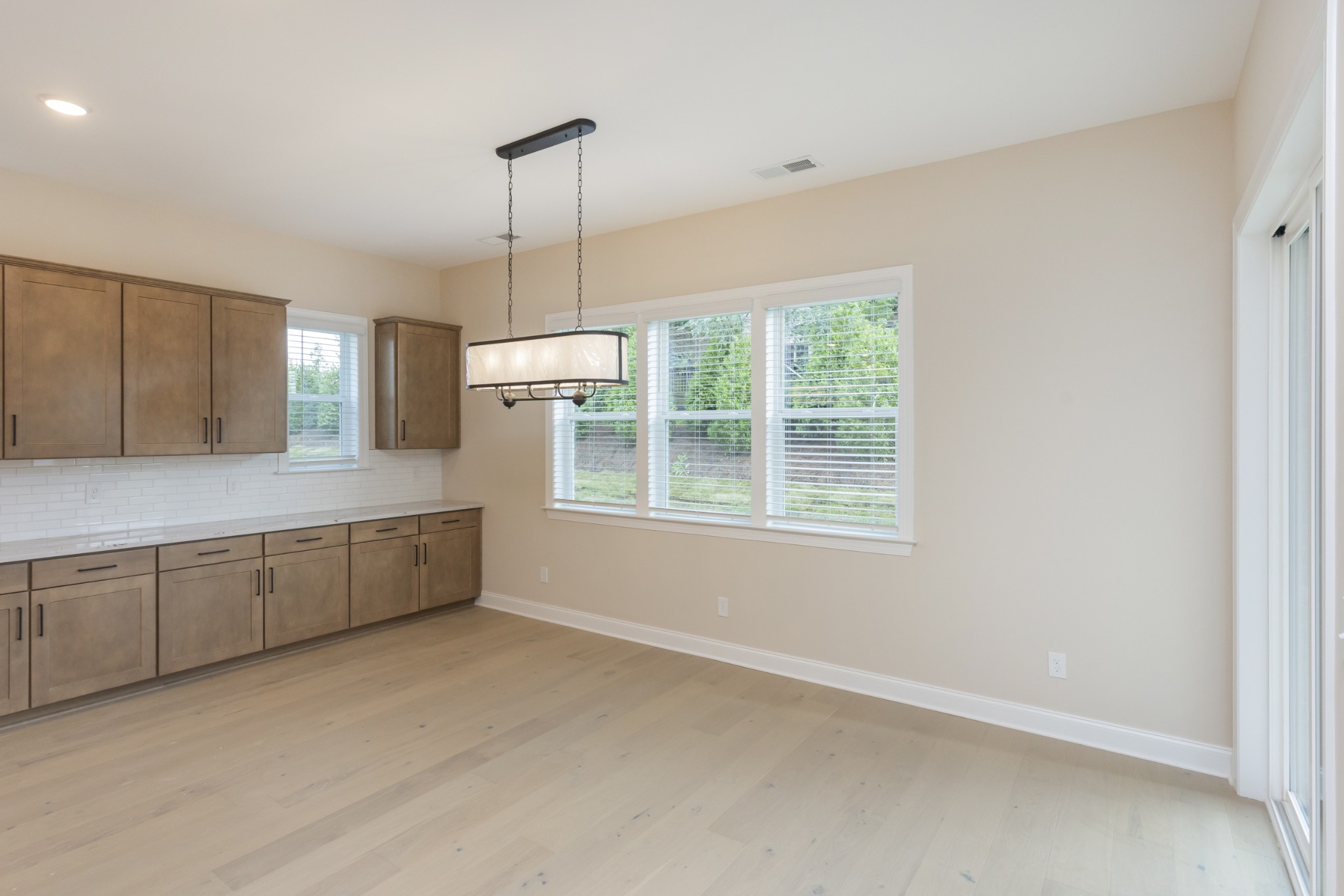 7006 Thunderhead Way Spring Hill, TN 37174 - Photo 18 of 58 a large kitchen with kitchen island white cabinets and stainless steel appliances