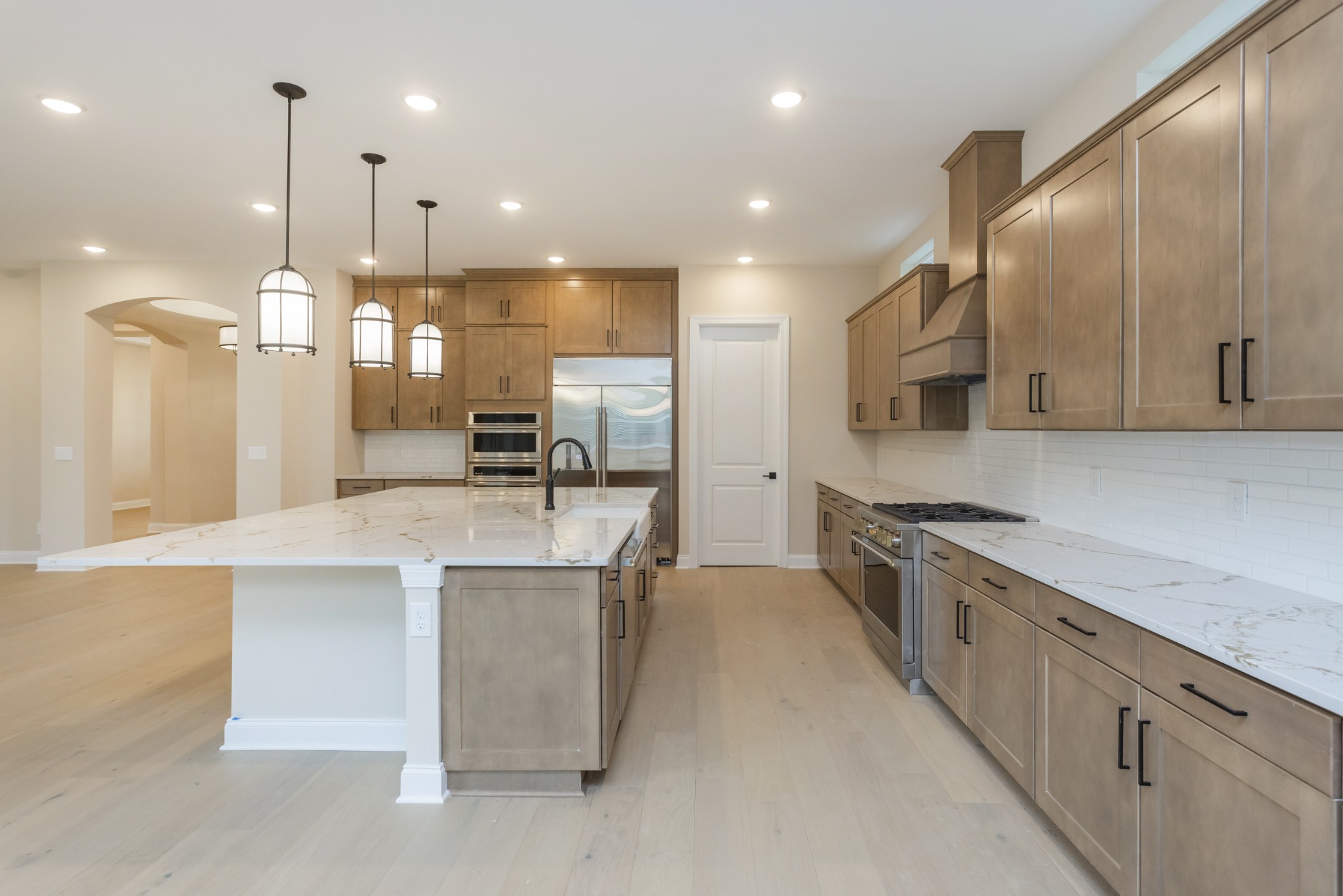 7006 Thunderhead Way Spring Hill, TN 37174 - Photo 24 of 58 a large kitchen with stainless steel appliances lots of counter space and a sink