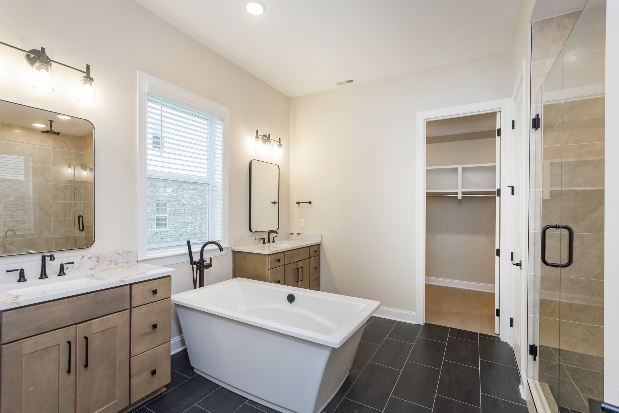 7006 Thunderhead Way Spring Hill, TN 37174 - Photo 29 of 58 a bathroom with a double vanity sink mirror and shower