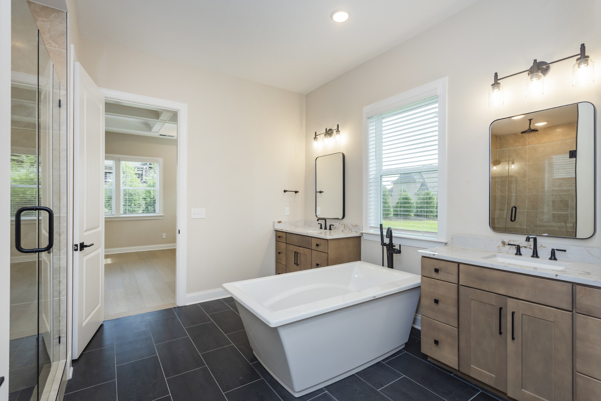 7006 Thunderhead Way Spring Hill, TN 37174 - Photo 30 of 58 a bathroom with a double vanity sink a mirror and a bathtub
