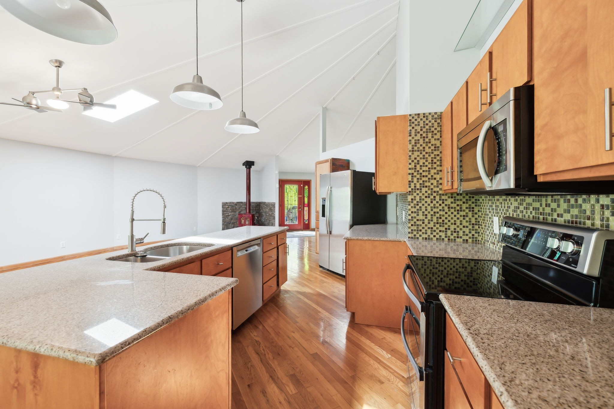 3055 Smith Springs Road Antioch, TN 37013 - Photo 19 of 59 a kitchen with stainless steel appliances granite countertop a sink a stove and a wooden floors