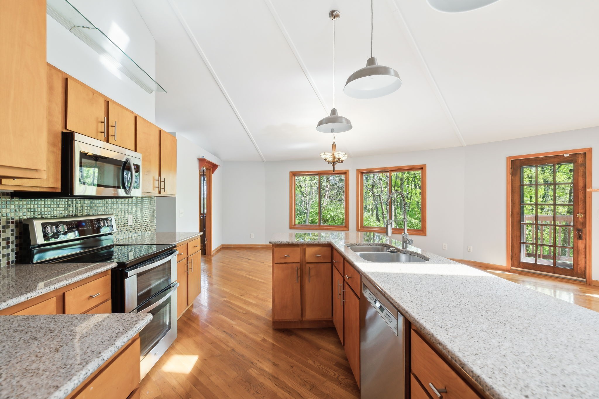 3055 Smith Springs Road Antioch, TN 37013 - Photo 21 of 59 a kitchen with stainless steel appliances granite countertop a sink a stove and a wooden floors