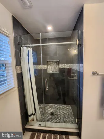 a bathroom with a glass door shower