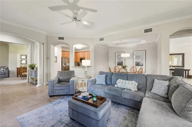 a kitchen with stainless steel appliances granite countertop a stove top oven a refrigerator and white cabinets