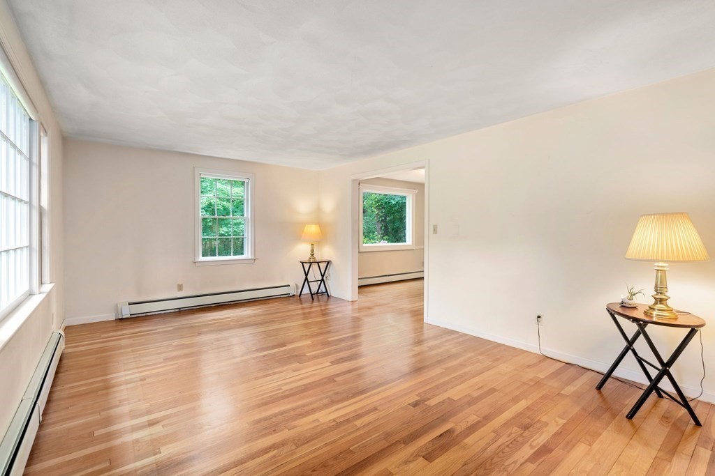 5 Parmenter Road Sudbury, MA 01776 - Photo 12 of 33 a view of an empty room with wooden floor and a window