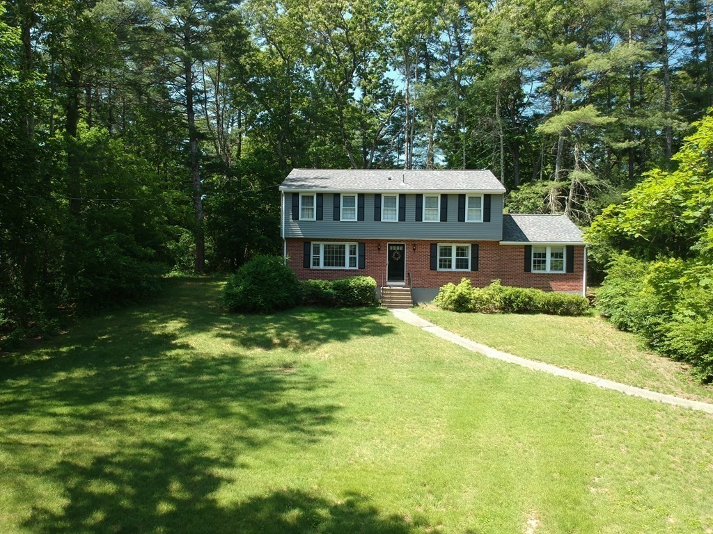 5 Parmenter Road Sudbury, MA 01776 - Photo 31 of 33 a front view of a house with a yard table and chairs