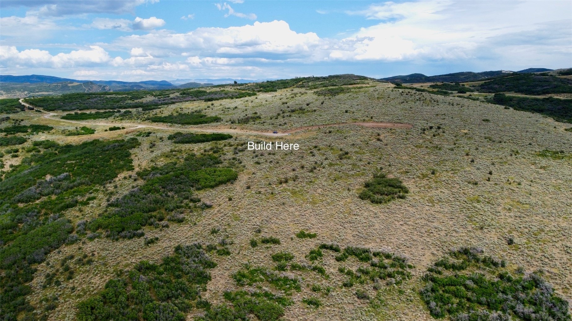 37700 Whitestone Place Hayden, CO 81639 - Photo 2 of 8 a view of a field with mountains in the background