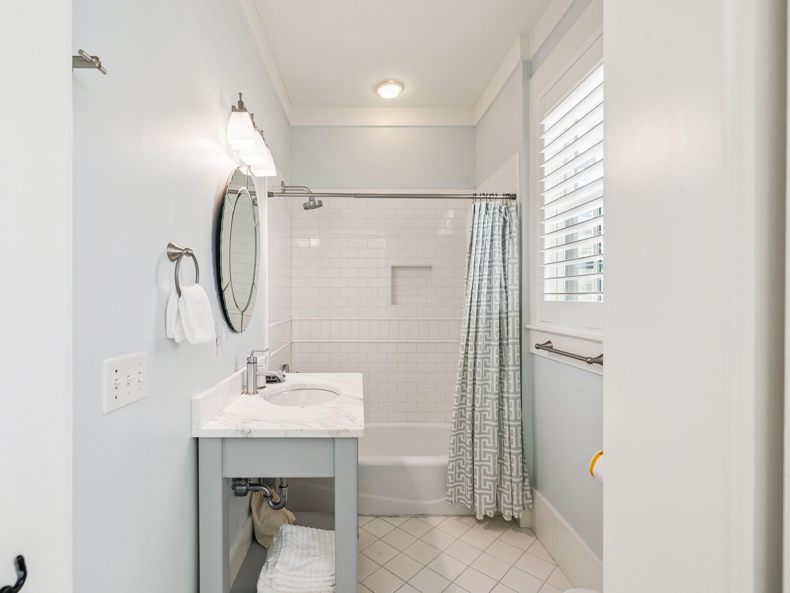 134 Spartina Circle Santa Rosa Beach, FL 32459 - Photo 31 of 41 a bathroom with a sink a mirror and a shower