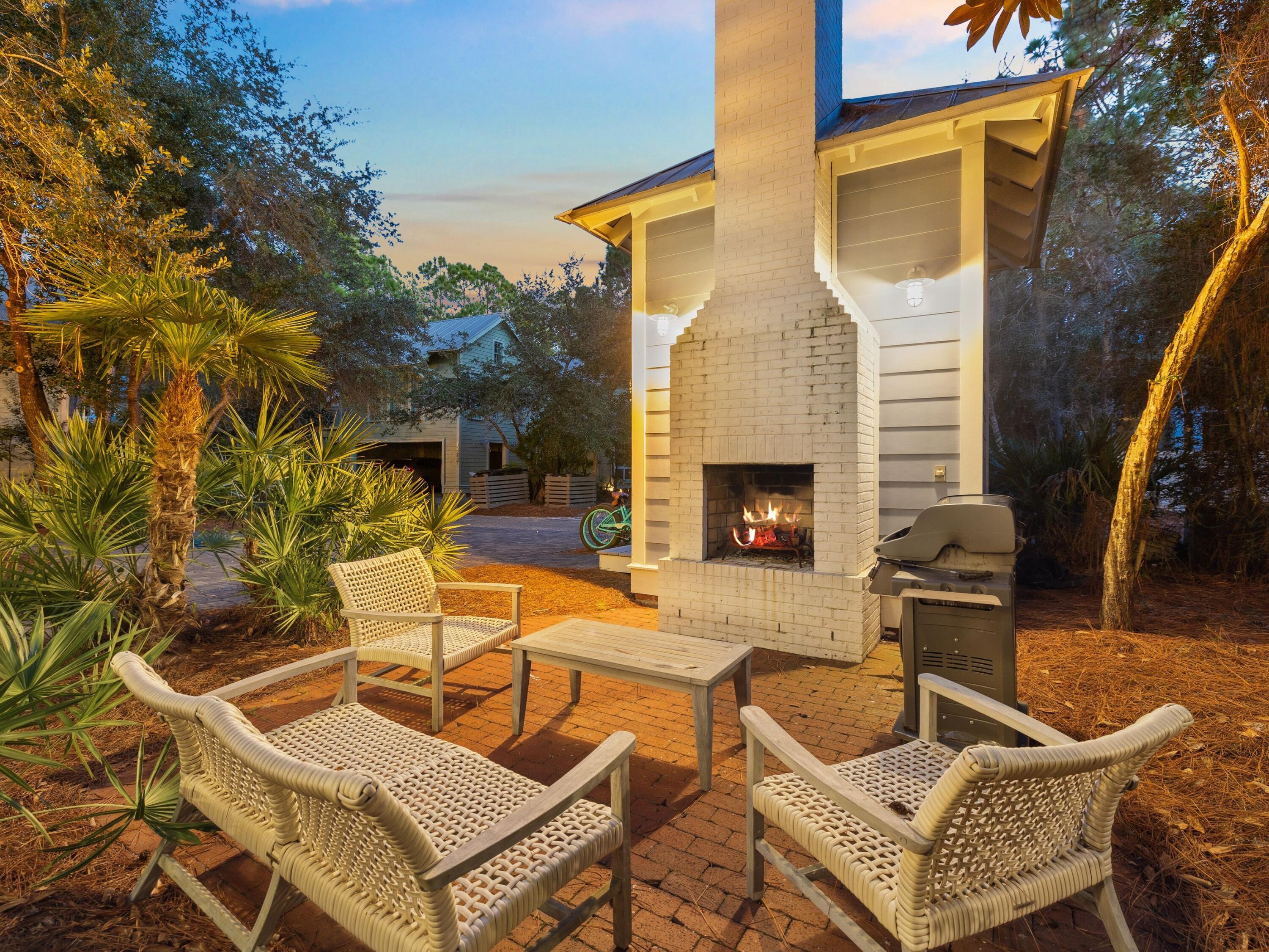 134 Spartina Circle Santa Rosa Beach, FL 32459 - Photo 34 of 41 a view of a patio with couches table and chairs with wooden floor and fence