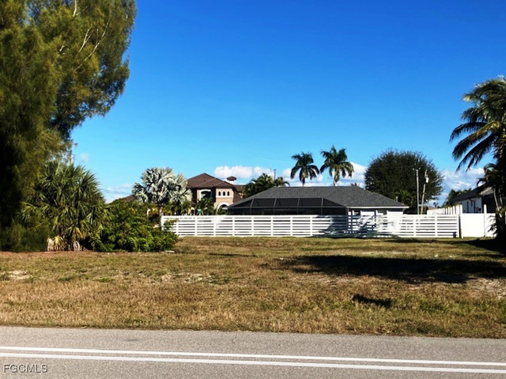101 Old Burnt Store Road South Cape Coral, FL 33991 - Photo 4 of 5 a view of swimming pool with outdoor seating and lake view