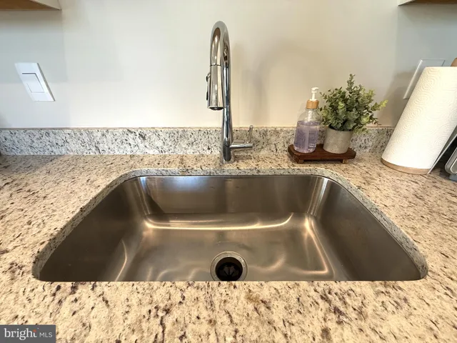 a living room with furniture a dining table and chairs with wooden floor