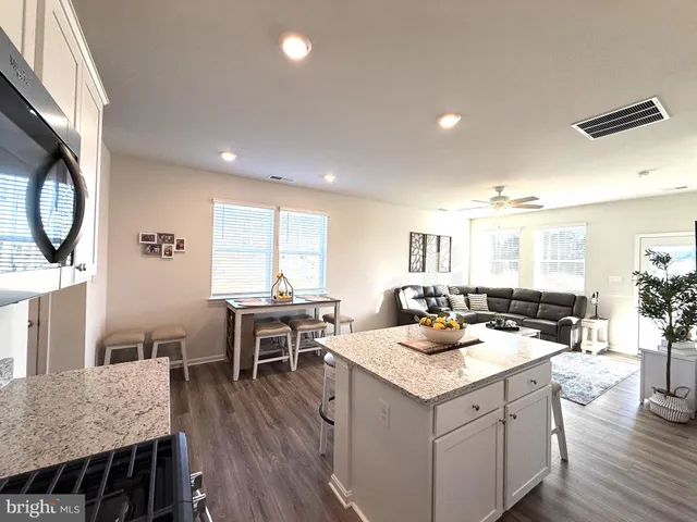a spacious bedroom with a bed and a chandelier