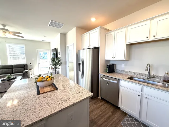 a bedroom with a bed and a chandelier fan