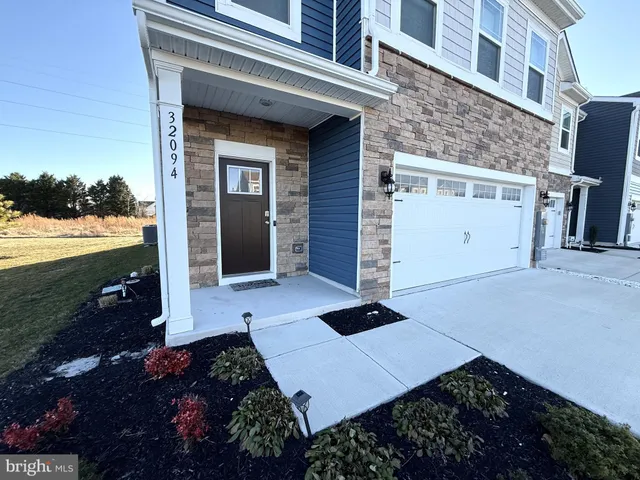 a kitchen with a refrigerator a stove a sink dishwasher and a microwave with wooden floor