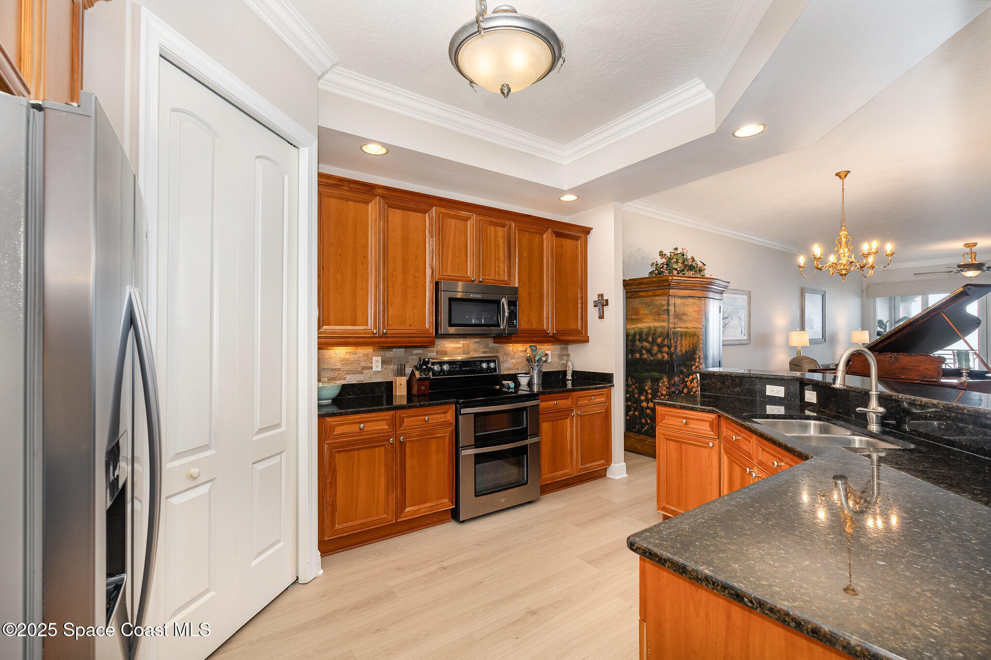 2022 Julep Drive, Unit 304 Cocoa Beach, FL 32931 - Photo 10 of 34 a kitchen with stainless steel appliances granite countertop a sink a stove and a refrigerator