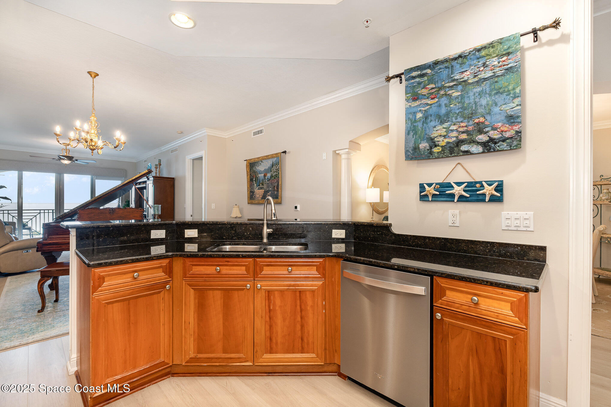 2022 Julep Drive, Unit 304 Cocoa Beach, FL 32931 - Photo 11 of 34 a kitchen with granite countertop a sink and a stove top oven
