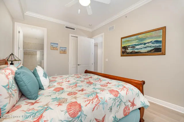 a bedroom with a bed and a painting on the wall