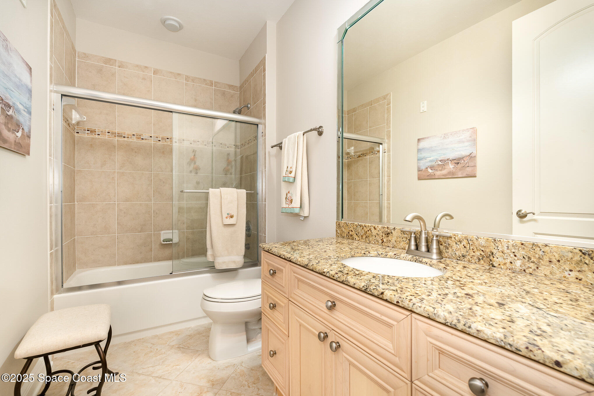 2022 Julep Drive, Unit 304 Cocoa Beach, FL 32931 - Photo 15 of 34 a bathroom with a granite countertop sink a toilet and shower