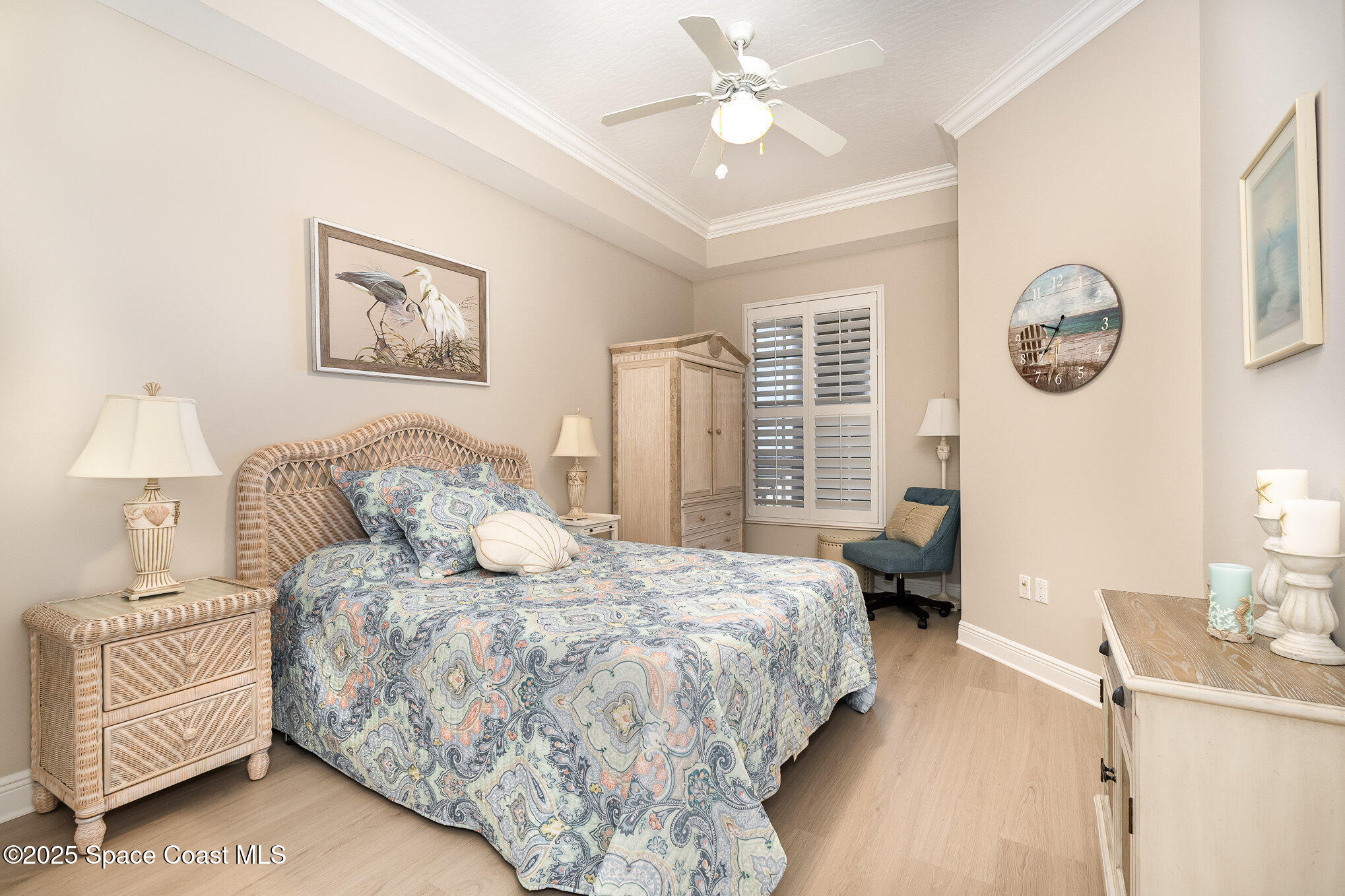 2022 Julep Drive, Unit 304 Cocoa Beach, FL 32931 - Photo 16 of 34 a bedroom with a bed and a chandelier