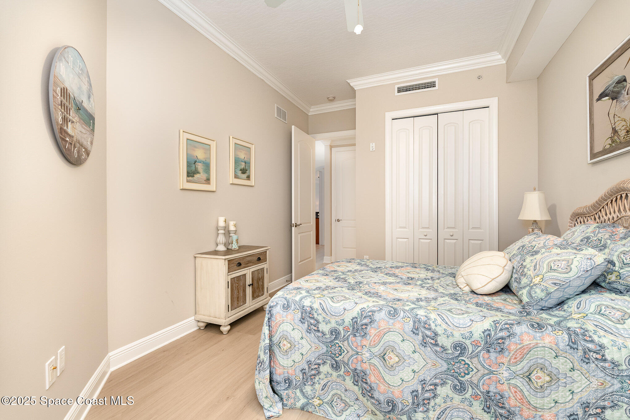 2022 Julep Drive, Unit 304 Cocoa Beach, FL 32931 - Photo 17 of 34 a bedroom with a bed and a chandelier