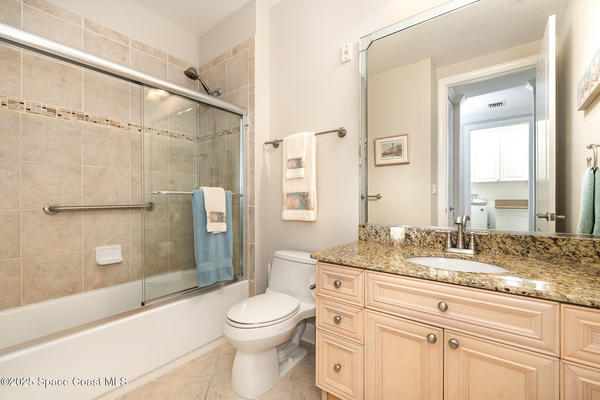 2022 Julep Drive, Unit 304 Cocoa Beach, FL 32931 - Photo 18 of 34 a bathroom with a granite countertop sink toilet and shower