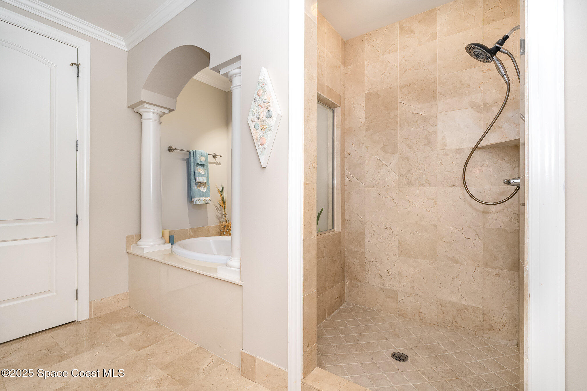 2022 Julep Drive, Unit 304 Cocoa Beach, FL 32931 - Photo 25 of 34 a bathroom with a glass shower door