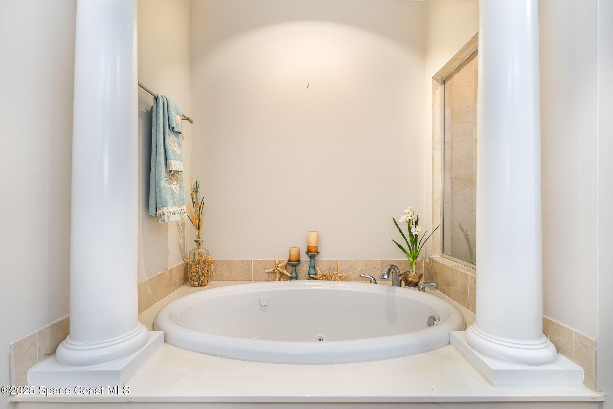 2022 Julep Drive, Unit 304 Cocoa Beach, FL 32931 - Photo 26 of 34 a bathroom with a white tub
