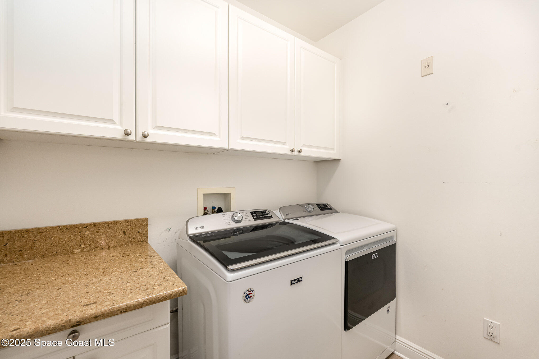 2022 Julep Drive, Unit 304 Cocoa Beach, FL 32931 - Photo 27 of 34 a kitchen with granite countertop white cabinets and a stove