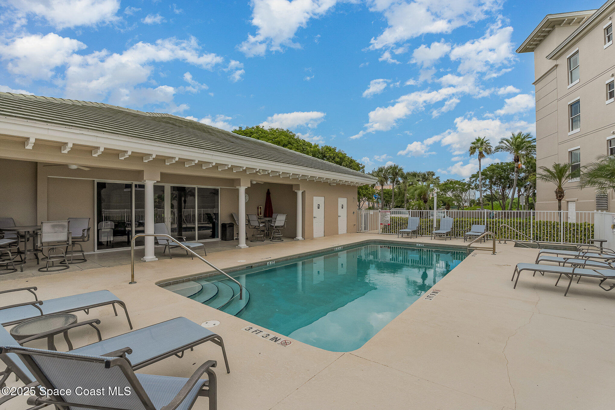 2022 Julep Drive, Unit 304 Cocoa Beach, FL 32931 - Photo 28 of 34 a view of a house with swimming pool and sitting area