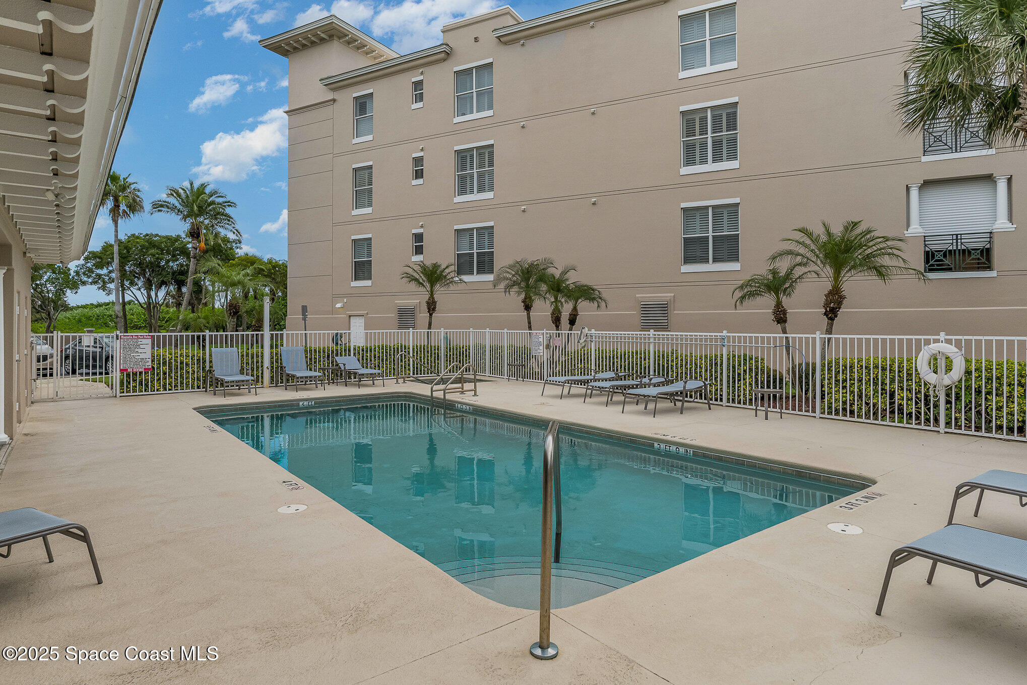 2022 Julep Drive, Unit 304 Cocoa Beach, FL 32931 - Photo 30 of 34 a view of a swimming pool with a patio